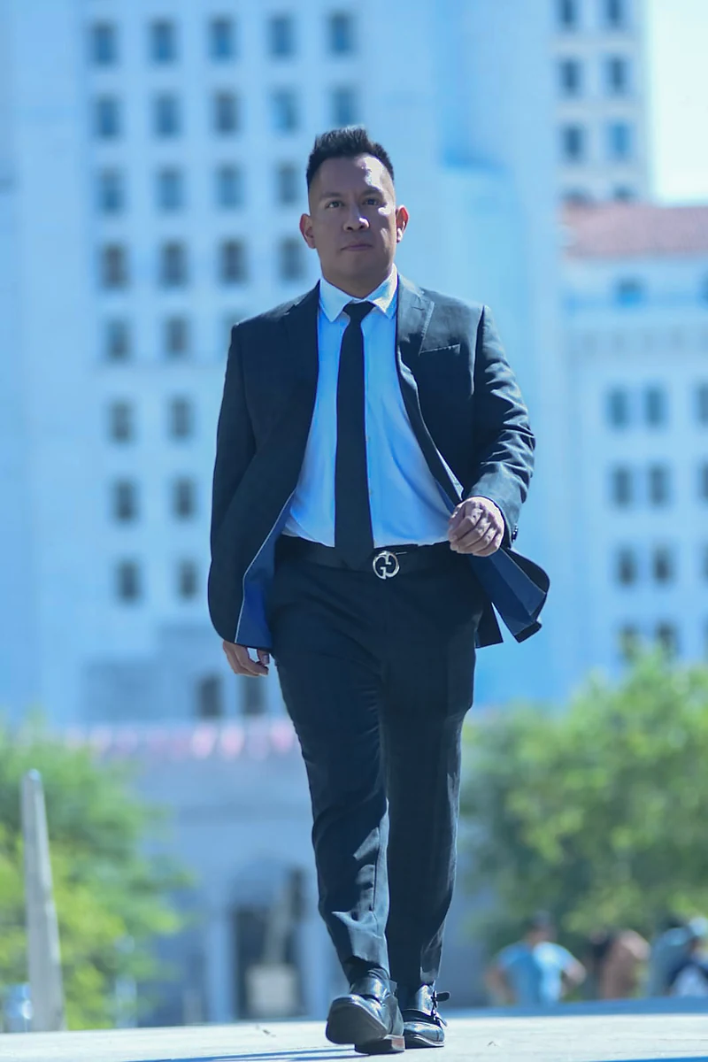 Oscar A. Ischiu walking outdoors