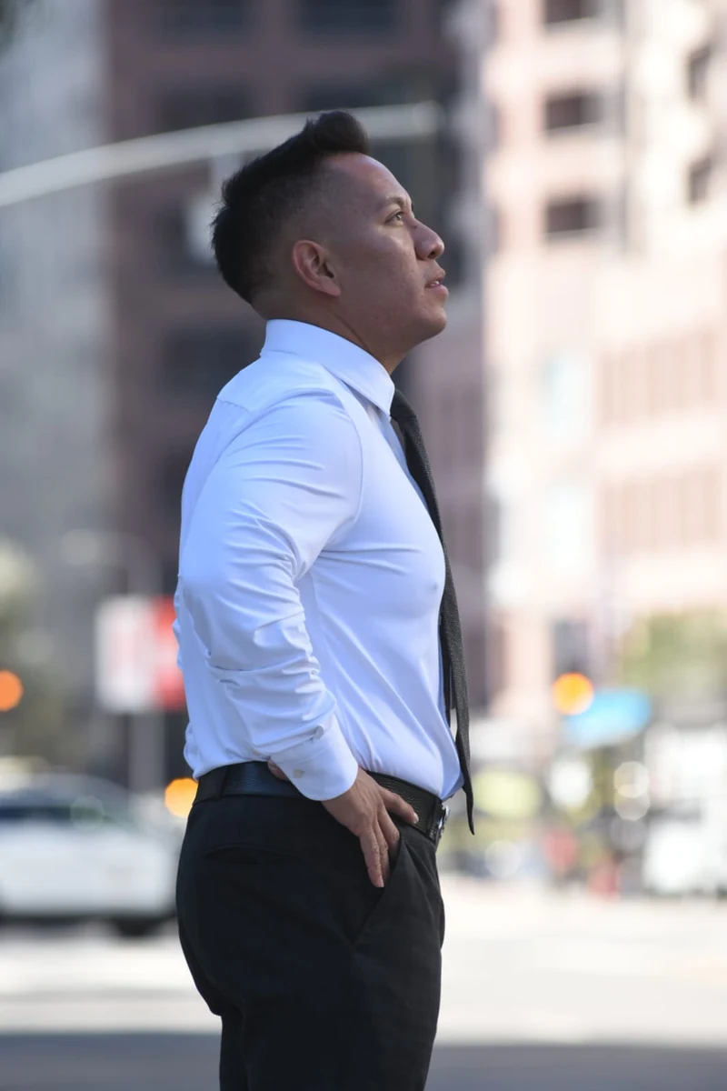 Oscar A. Ischiu reflecting outdoors in downtown Los Angeles